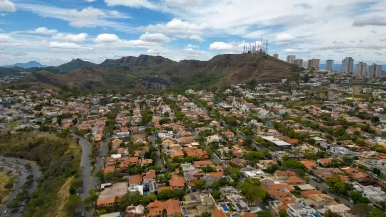 Serra Mesa, California neighborhood with residential homes, tree-lined streets, and views of surrounding hills under a clear sky.