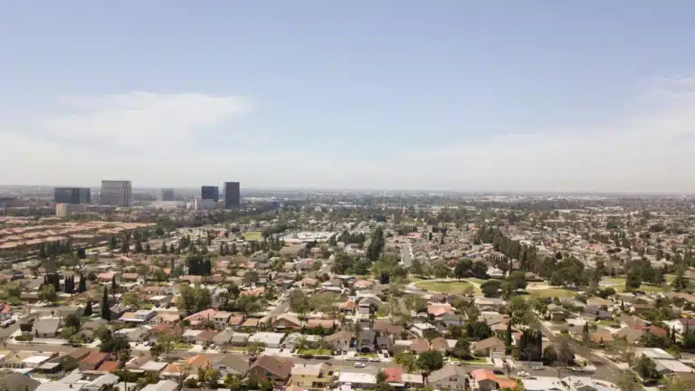 Serra Mesa, California neighborhood with residential homes, tree-lined streets, and views of surrounding hills under a clear sky.